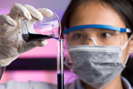 scientist pouring chemical